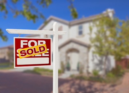 Sold sign in front of a residential home